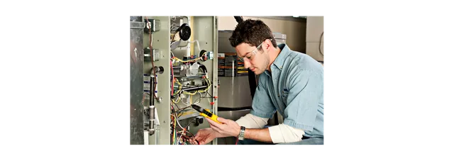 Image of a person checking the furnace