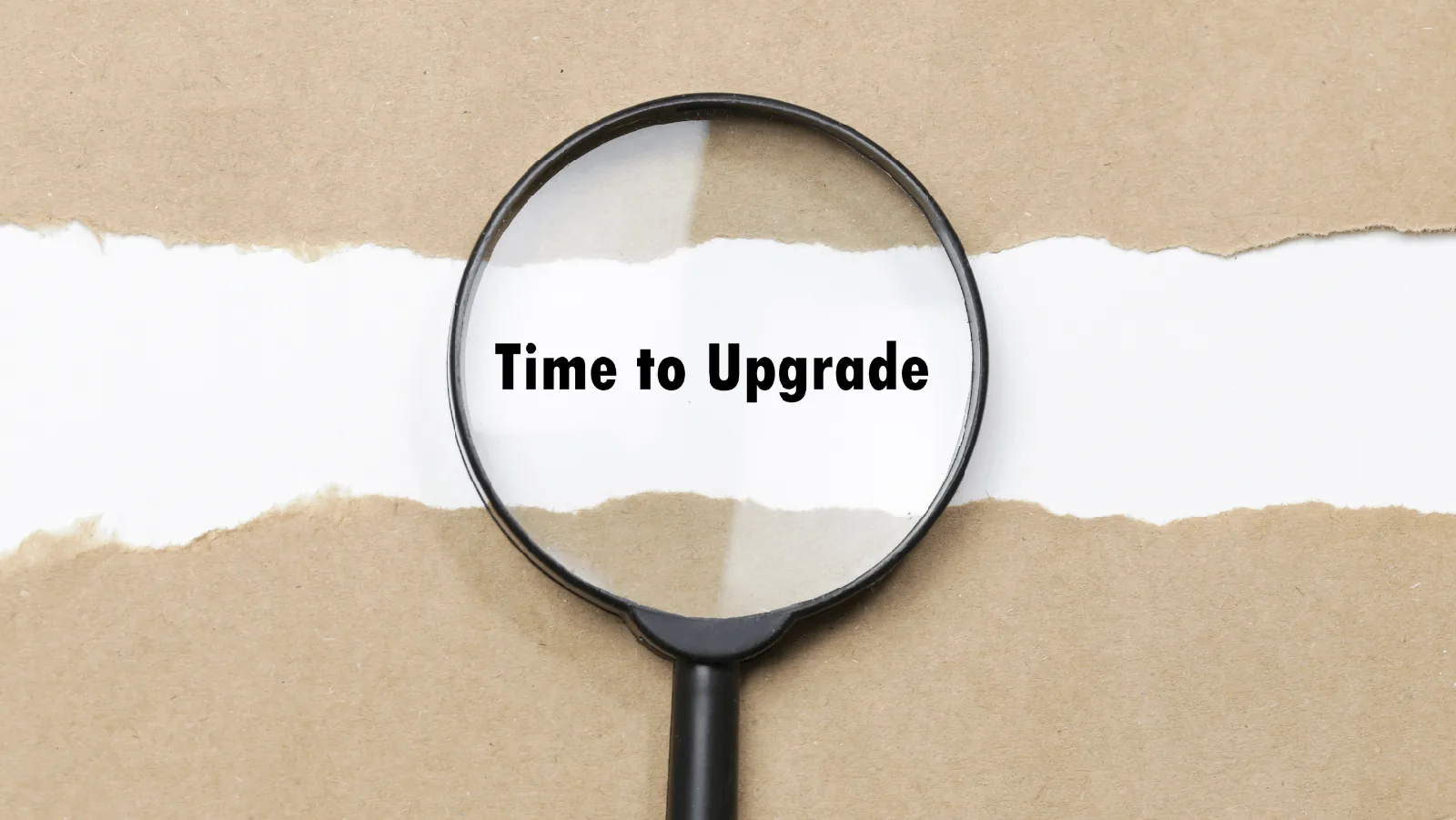 Magnifying glass highlighting the text "Time to Upgrade" on a torn paper background, symbolizing the need for HVAC system upgrades.