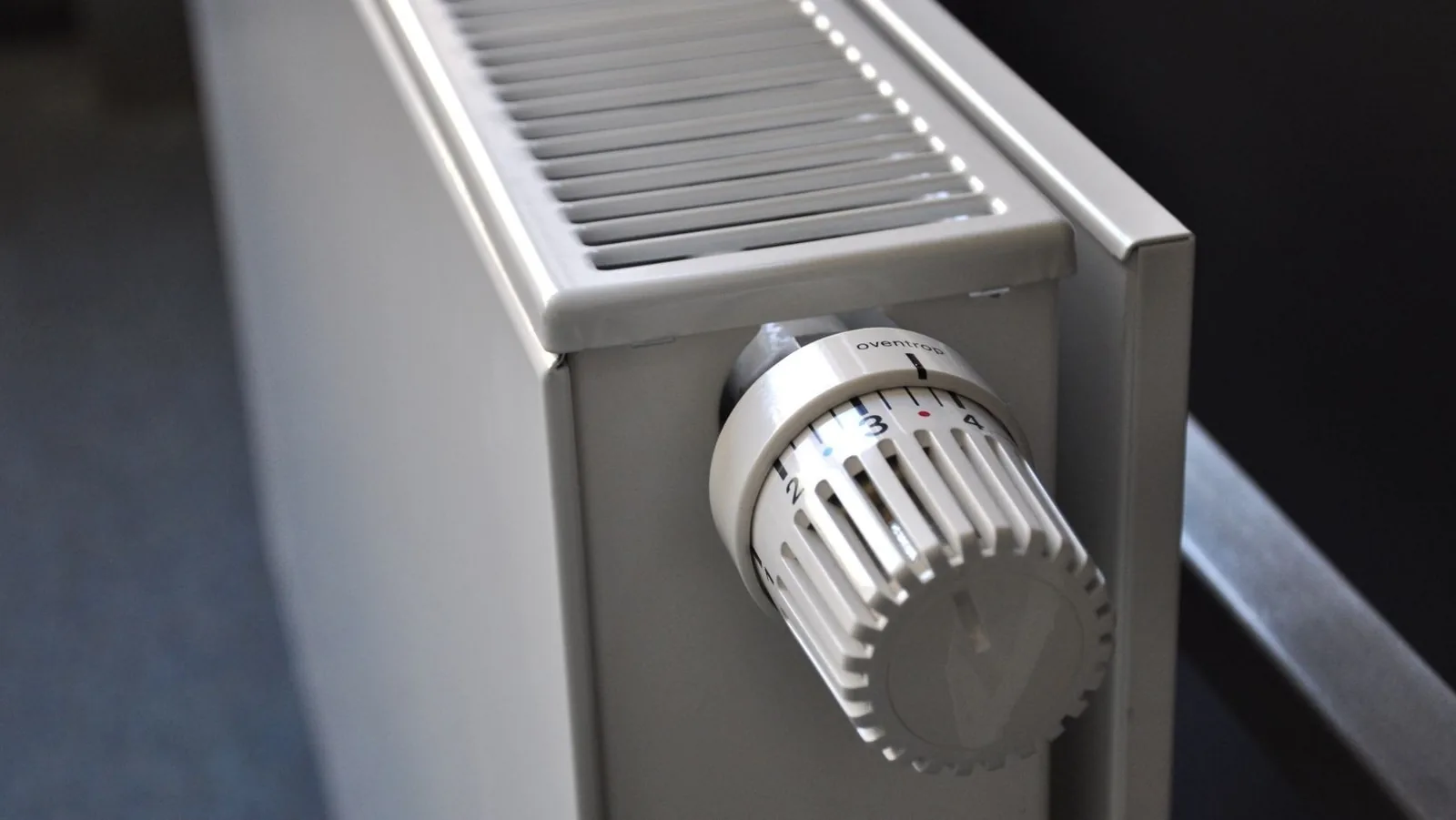 Heating radiator with adjustable thermostat dial, relevant to home heating tips and HVAC services.