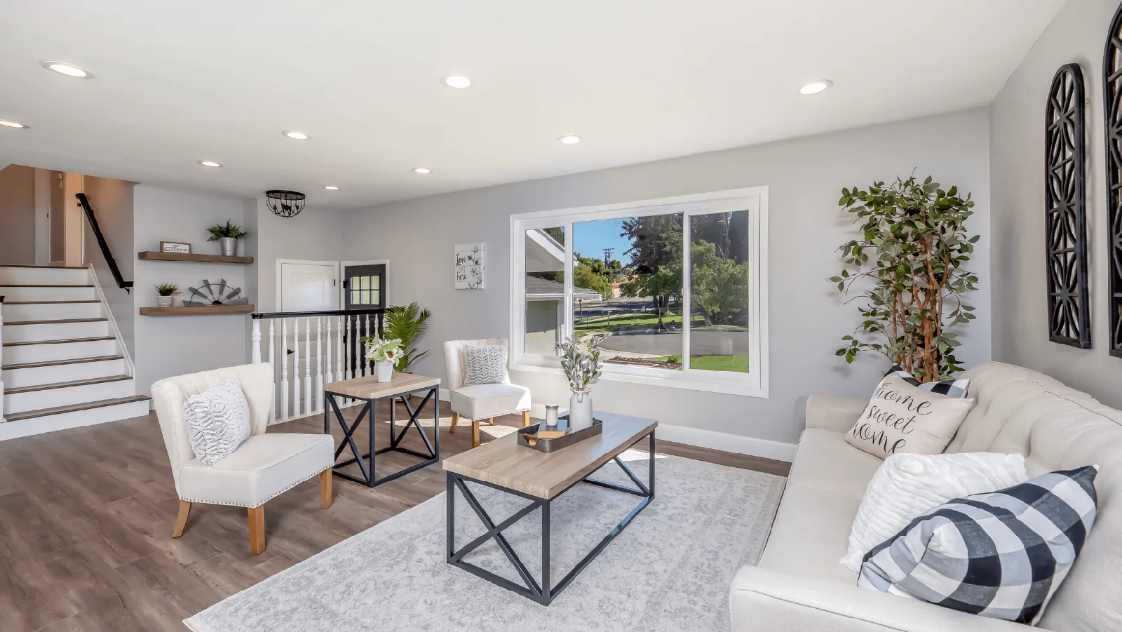 Modern living room with a cozy sofa, decorative pillows, and stylish furniture, showcasing a bright interior with
