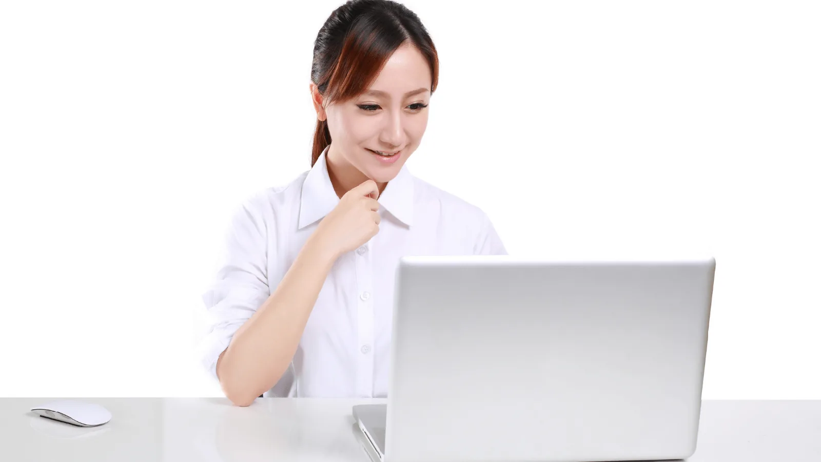 Person in a white shirt smiling while using a laptop, illustrating HVAC maintenance planning and customer service engagement.