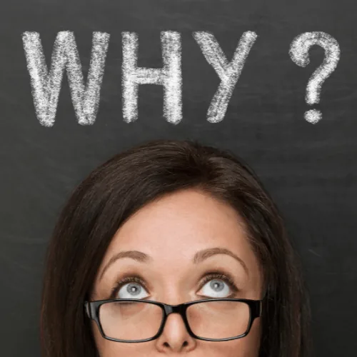 Woman looking up with glasses under the word "WHY?" on a chalkboard, symbolizing confusion about HVAC issues like tripping breakers.