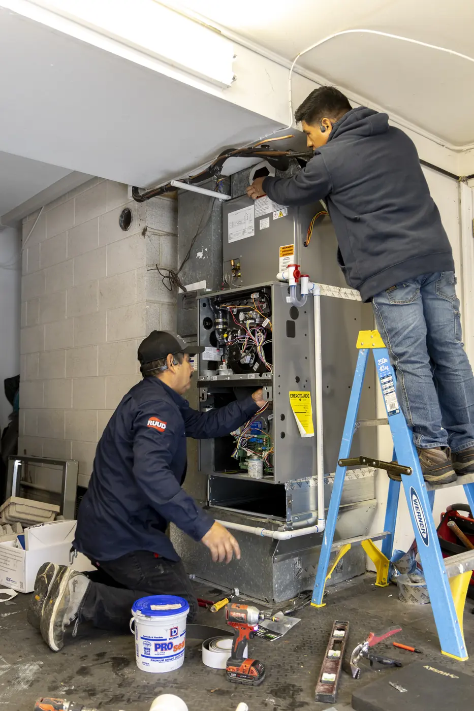 Technicians connecting a newly installed air handler