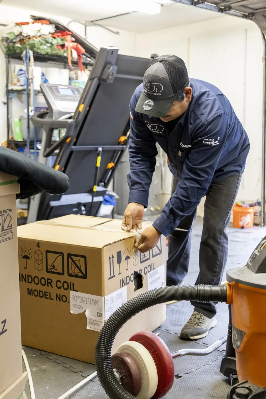 Technician unboxing a new indoor coil