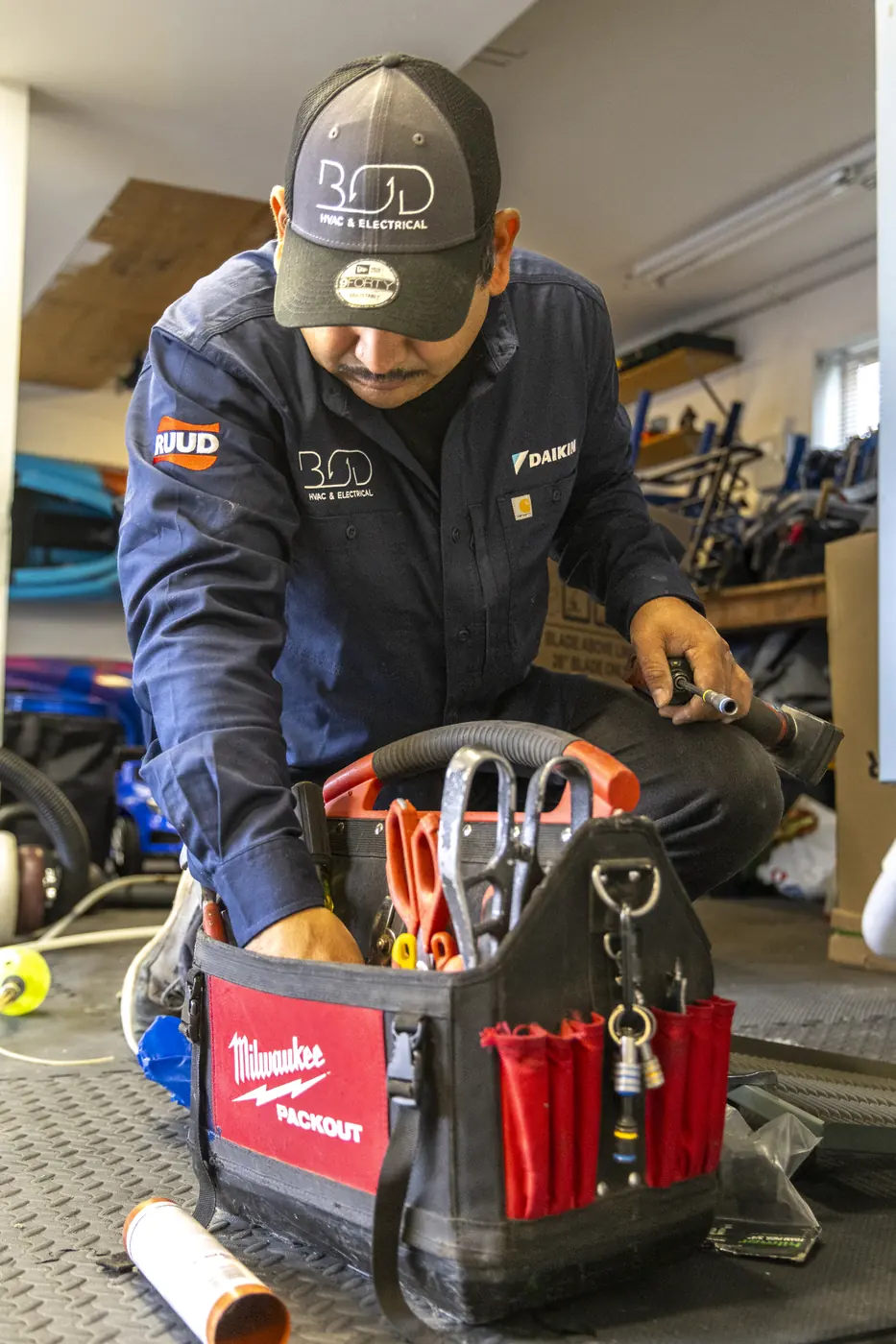 Technician selecting tools from a packed tool bag