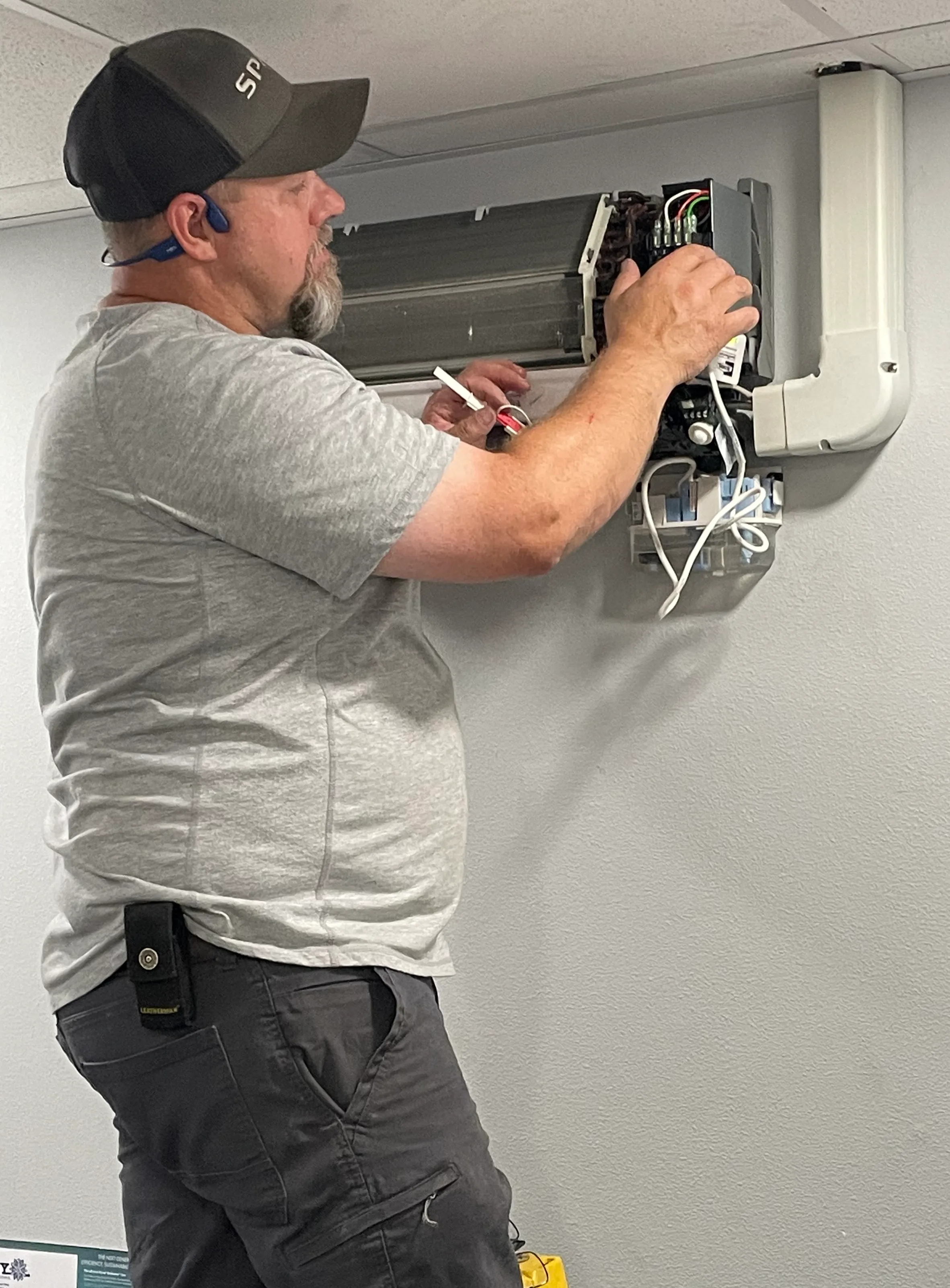 Owner Kevin wiring a ductless mini-split indoor head unit