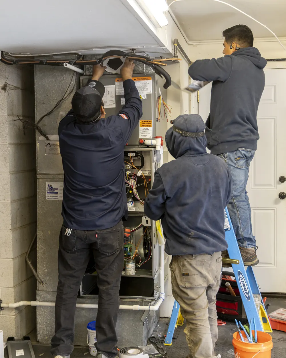 Best Owner Direct HVAC & Electrical technicians installing an air handler